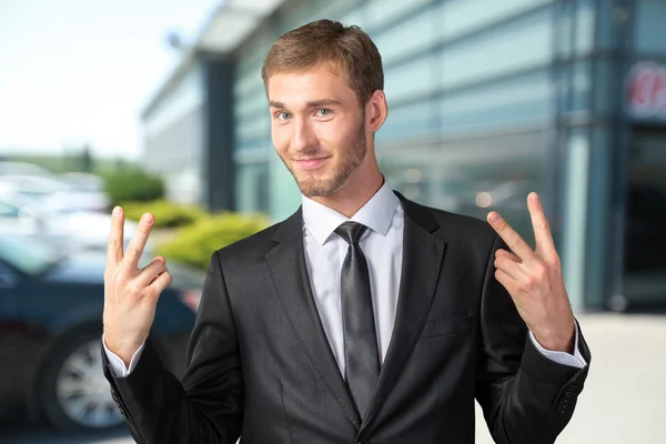 Businessman showing victory sign Stock Image