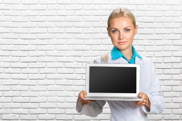 Женщина-врач держит ноутбук — стоковое фото
