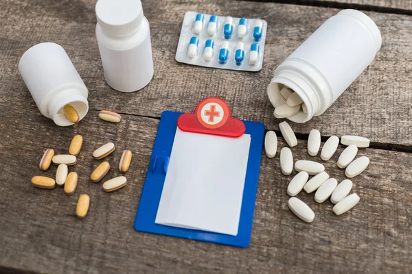 Round pills on wood table — Stock Photo, Image
