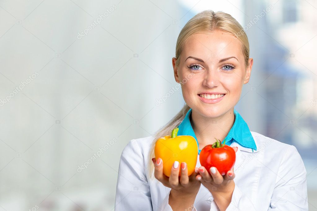 Happy Female Dietician With Fresh Vegetables
