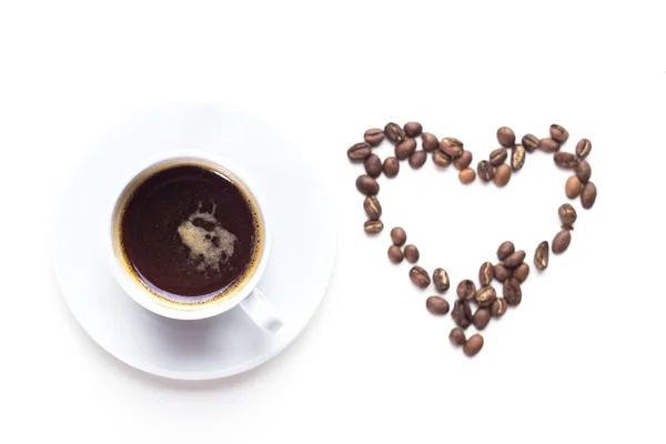 Кофейная чашка и кофейные зерна — стоковое фото