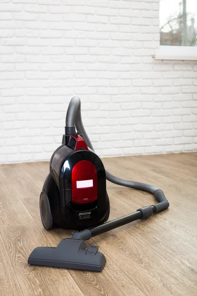 Cleaning of the apartment. Vacuum cleaner on the floor — Stock Photo, Image