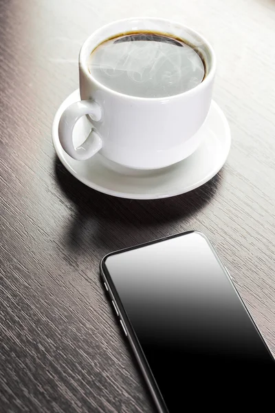 A cup of decorated cappuccino and smart phone — Stock Photo, Image