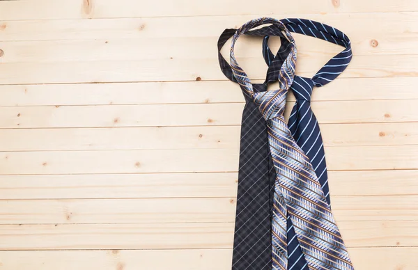 Ties laid on wooden floor — Stock Photo, Image