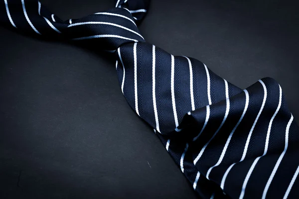 Man\'s tie on dark background