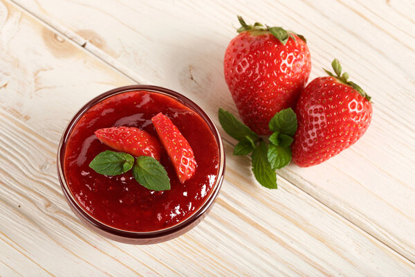 strawberry jam on a wooden background