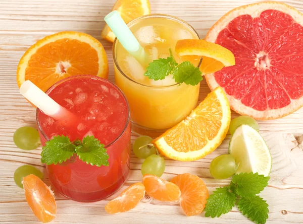 Fresh juices on a wooden background — Stock Photo, Image