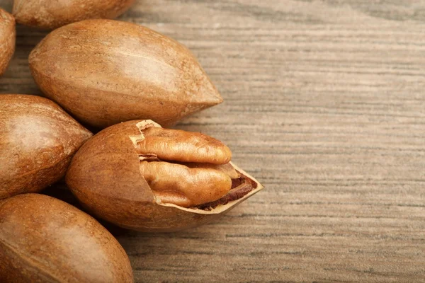 pecan nuts on wooden background