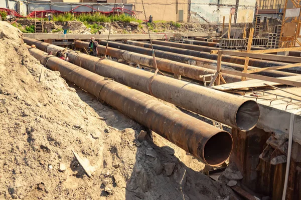 Large iron pipes at a construction site