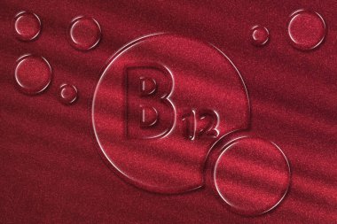 Vitamin B12 sağlık sembolü, vitamin konsepti, siyanocobalamin, hidroksokobalamin, Methylcobalamin, Adenosylcobalamin, metabolizma, kırmızı kan hücrelerinin oluşumu, kırmızı zemin