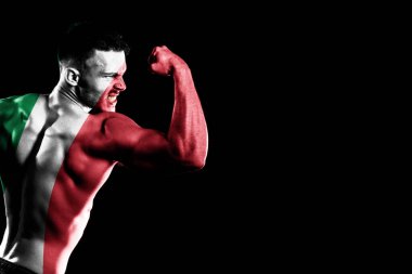 Yakışıklı, genç, kaslı bir adamın siyah arka planında İtalya bayrağı