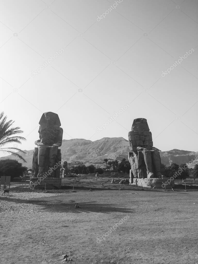 The Colossi of Memnon are  two monumental statues representing Amenhotep III (1386-1353 BCE) 