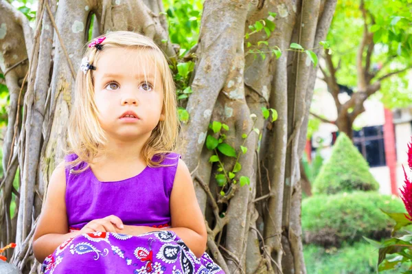 Malá holčička v tropické zahradě. bonsaje strom — Stock fotografie