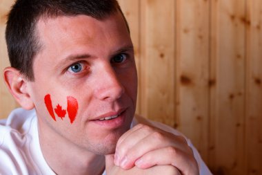 canadian flag on the face of young man clipart
