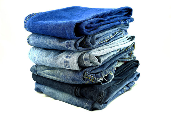 Джинсы кучу изолированы на белом фоне
