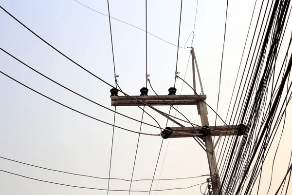 Energy and technology: electrical post by the road with power line — Stock Photo, Image