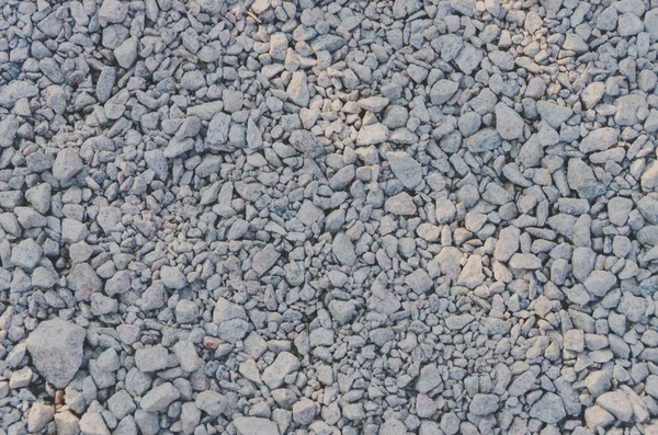 Patrón gris grava granito textura fondo para mezclar patrón de hormigón de roca en la construcción industrial. Pequeño guijarro gris en el suelo o el suelo. Vintage y retro — Foto de Stock