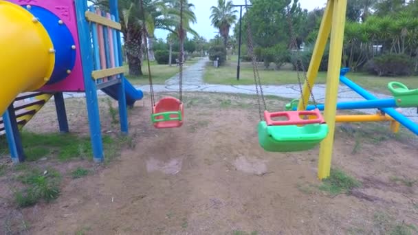 The on the playground swing without people loneliness and quarantine — Wideo stockowe
