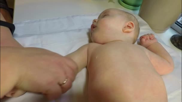 The baby boy is given a medical massage and gymnastics — Stock Video
