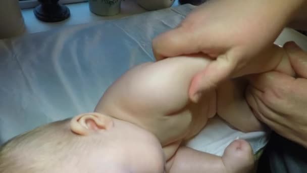 The baby boy is given a medical massage and gymnastics — Stockvideo