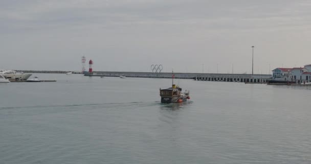 SOCHI, RUSSLAND - 13. Mai 2021. Altmodisches Motorboot verlässt den Seehafen von Sotschi. — Stockvideo