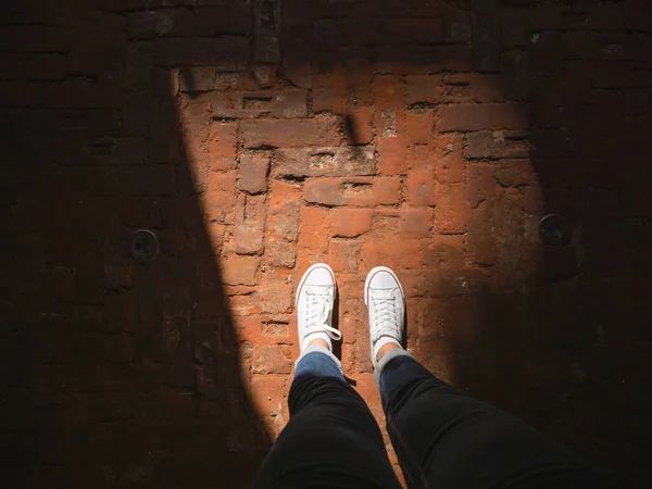 Mujer Zapatillas Blancas Encuentra Rayo Sol Pavimento Viejo Hecho Ladrillos — Foto de Stock