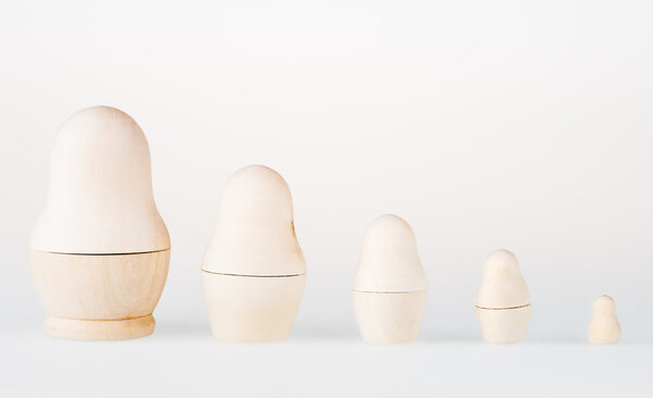 Set of nesting dolls, standing in a row. Russian traditional toy, named matryoshka, on white background.