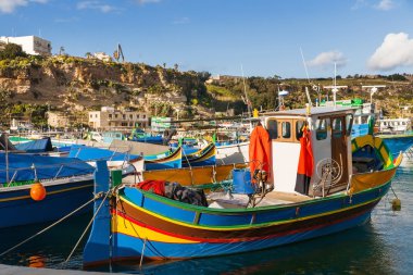 Port of Mgarr on the small island of Gozo, Malta. Traditional maltese colorful painted fishing boat.
