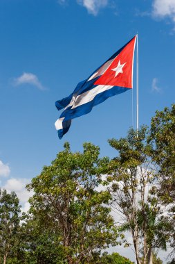 The Cuban state flag flutters on a wind. Sunny windy weather in Habana, Cuba island.