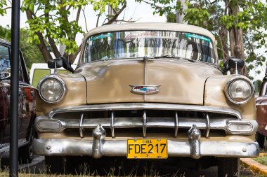 HAVANA, CUBA - February 5, 2008. Classic Chevrolet parking near palm trees. Most of the Cubans drive cars that were on the road before 1959.
