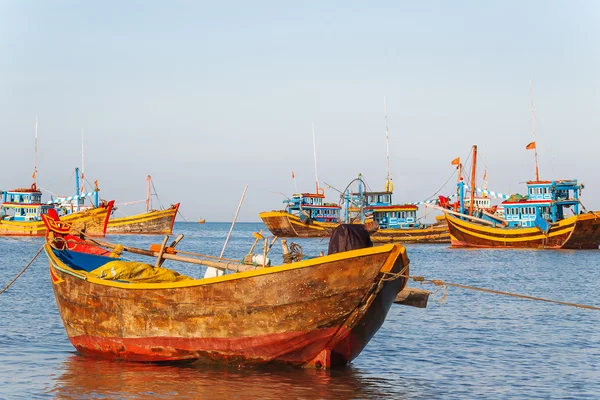 Coloridos barcos de pesca tradicionales cerca de Mui Ne, Binh Thuan, Vietnam. Temprano en la mañana, los pescadores flotan a la costa con una captura . — Foto de Stock