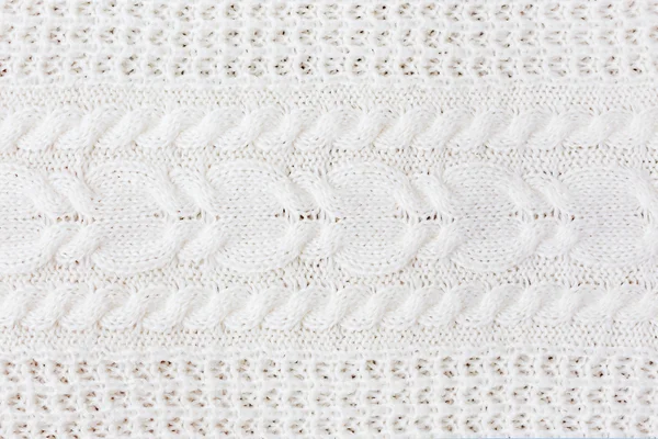 抽象的な背景を編んだ。ウールの白いセーターのテクスチャです。ニット パターンの画像を閉じる. — ストック写真