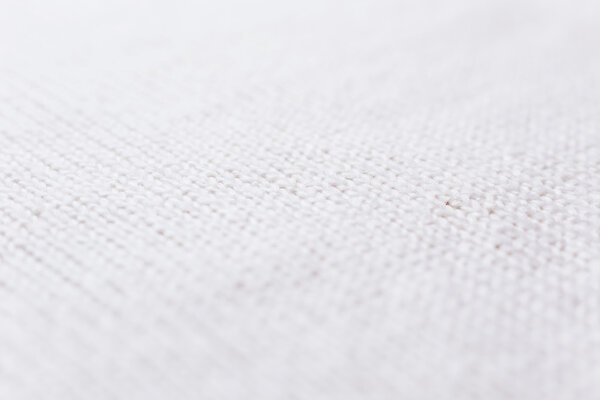 Abstract knitted background. Wool white sweater texture. Diagonal close up picture of  knitted pattern.