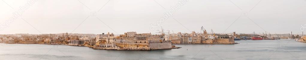 Large panorama of Senglea (Isla) city. Early foggy winter morning in Malta.