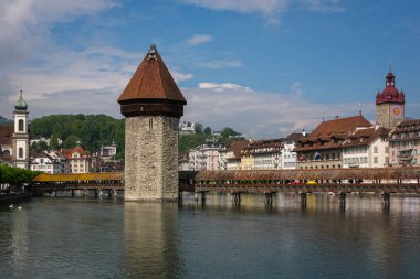 The Chapel Bridge is a covered wooden footbridge spanning the river Reuss diagonally in the city of Lucerne in central Switzerland. Named after the nearby St. Peter's Chapel, the bridge is unique in containing a number of interior paintings.