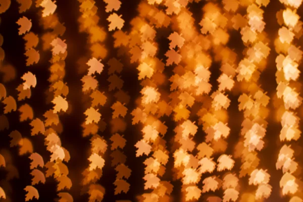 Blurring lights bokeh background of golden leaves — Stock Photo, Image