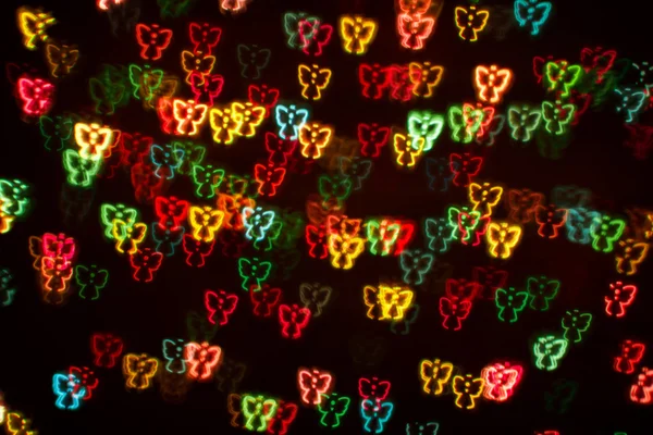 Blurring lights bokeh background of colorful angels — Stock Photo, Image