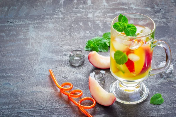 summer drink Peach Sweet Tea with ice and mint, copy space