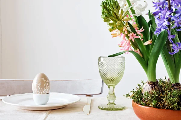 Easter table setting with natural Hyacinths flowers in wooden bowl. Zero Waste Easter, home festive atmosphere