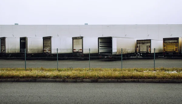 Refrigerator semi-trailers in a row parked on large distribution center