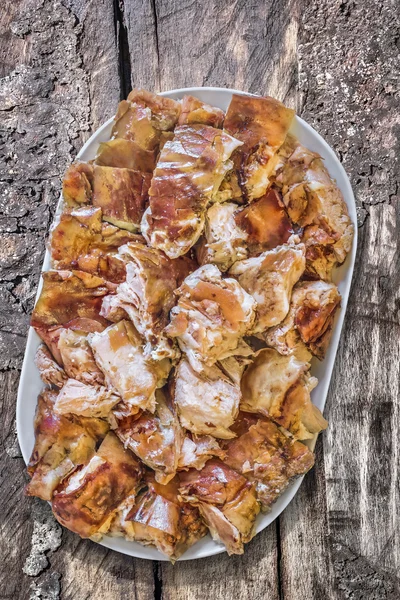 Eski ahşap piknik masa Domuz eti dilimleri tabak dolusu tükürük kavrulmuş — Stok fotoğraf