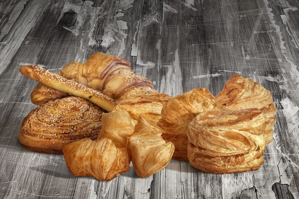 Bunch of Sesame Croissant Puff Pastry On Old Scratched Cracked Flaky Wooden Surface