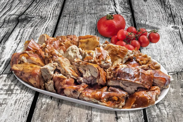 Plateful of Spit Roasted Pork Slices With Bunch of Tomato On Old Wooden Background — Stock Photo, Image