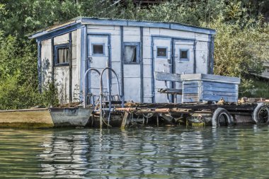 Old Wooden White-Blue Raft Weekend House on Sava River