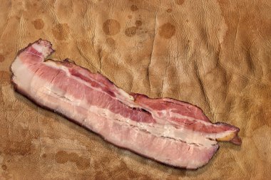 Pork Belly Rasher On Old Brown Crumpled Stained Cowhide