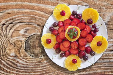 Plateful Of Orange And Strawberries Slices With Cherries Isolateted on White Background