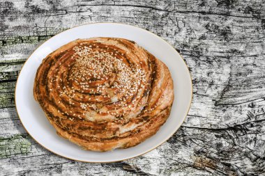 Puff Paste Sesame Roll In Porcelain Plate On Wooden Backdrop