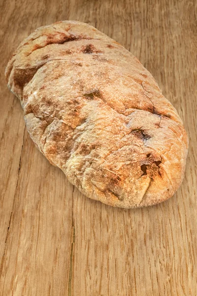 Bochenek chleba pita na rustykalny dąb drewniany stół — Zdjęcie stockowe