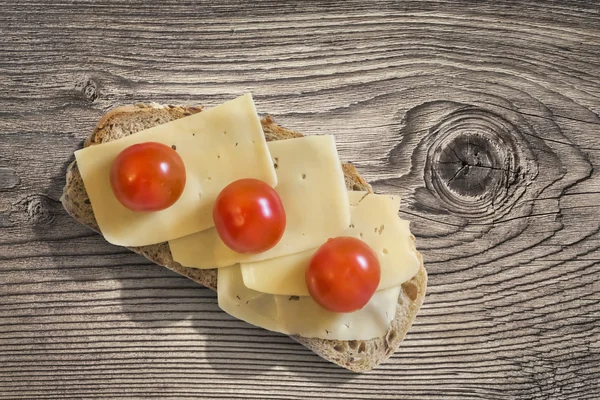 Cheese And Cherry Tomato Sandwich On Old Cracked Knotted Wooden Surface