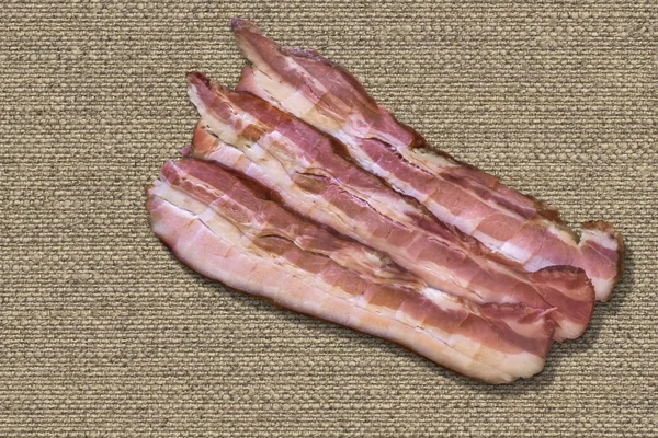 Three Belly Bacon Rashers On Natural Linen Canvas Background — Stock Photo, Image